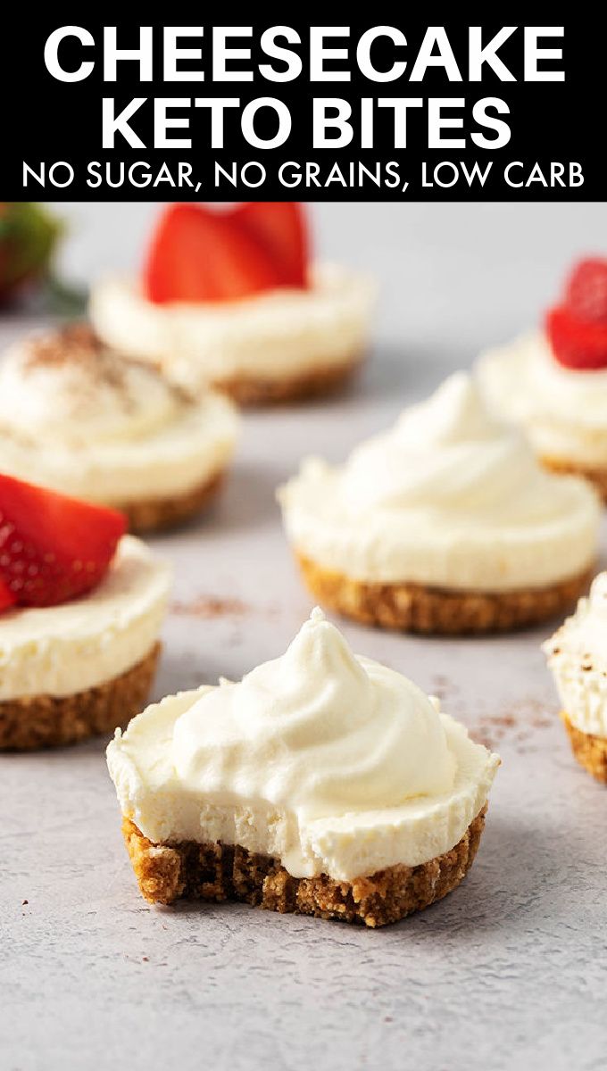 no bake cheesecake keto bites on a baking sheet with strawberries in the background