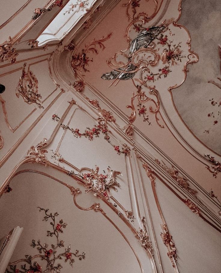 an ornately decorated ceiling with pink and gold paint on the walls is shown in this photo