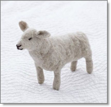 a stuffed animal standing on top of a white blanket