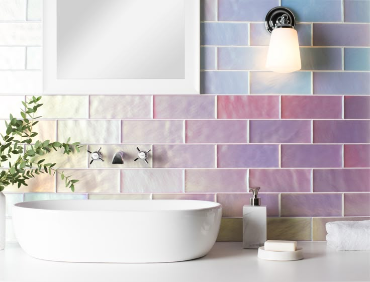 a white sink sitting under a bathroom mirror next to a wall mounted faucet