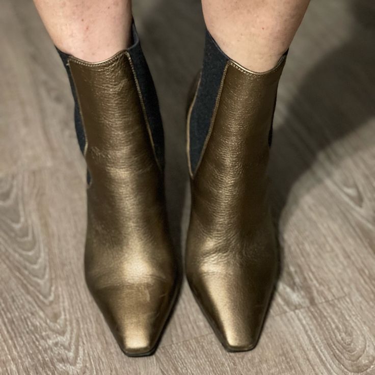 Brunello Cucinelli Metallic Bronze Leather Boot With Monili Detail Down The Back Of The Boot. Only Worn A Handful Of Times. Comes With Box And Dust Bag. Size 37 Us Size 7 Beautiful Boot Gold Leather Boots With Reinforced Heel, Gold Leather Heeled Boots With Reinforced Heel, Elegant Gold Leather Boots, Gold Leather Boots With Almond Toe, Gold Almond Toe Leather Boots, Gold Luxury Calf Leather Boots, Luxury Gold Calf Leather Boots, Luxury Metallic Boots With Pointed Toe, Luxury Metallic Pointed Toe Boots