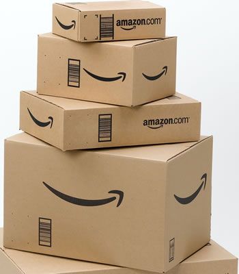 three boxes with faces drawn on them are stacked in the shape of an amazon box