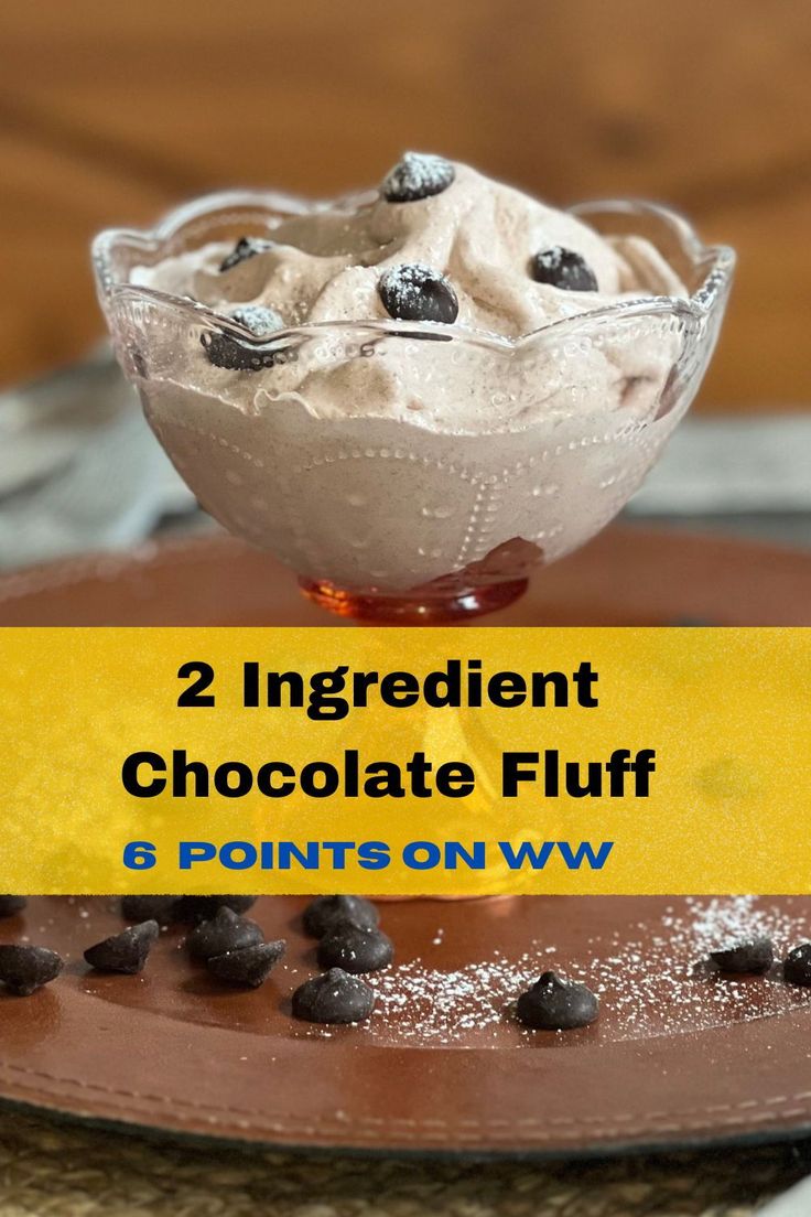 two ingredient chocolate fluff in a glass bowl on top of a plate with chocolate chips