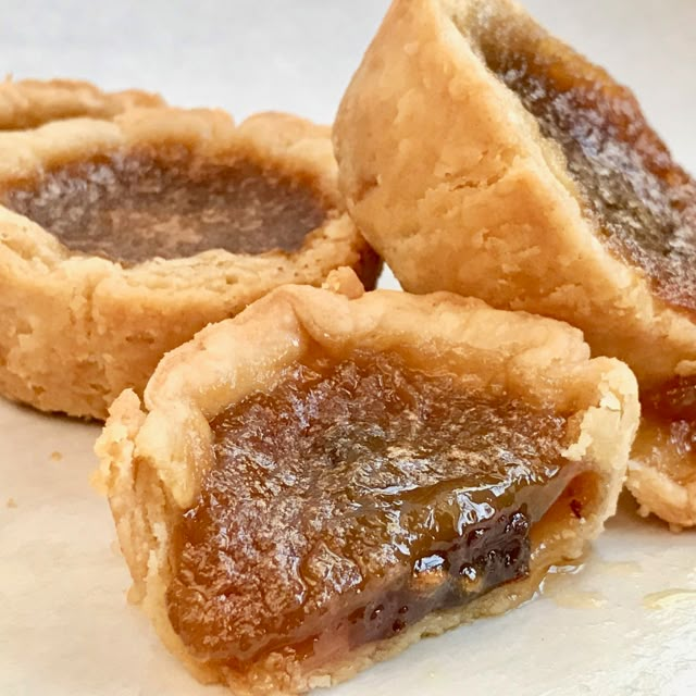 three pieces of pie sitting on top of a white plate