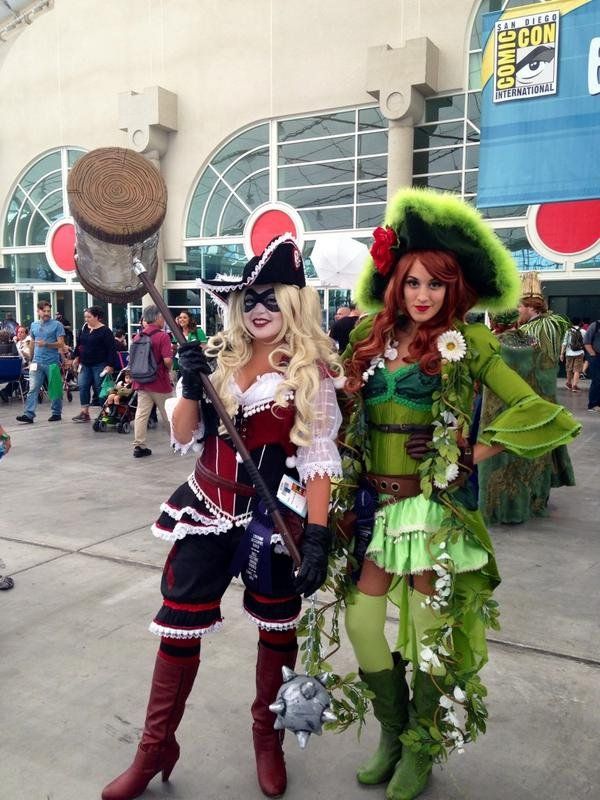 two women dressed in costumes standing next to each other