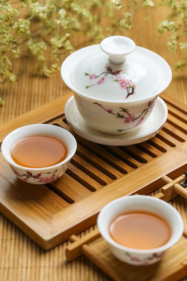 two cups of tea sitting on top of a wooden tray