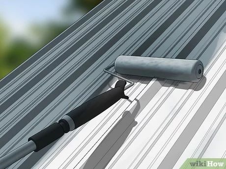 a painting roller on the side of a metal roof