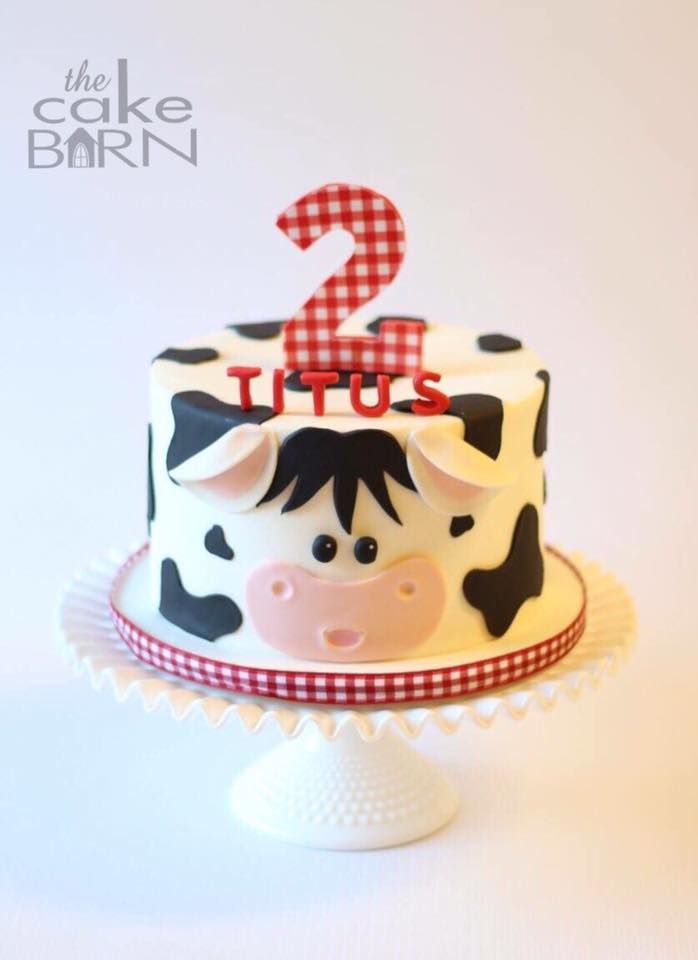 a cake decorated with a cow and the number two