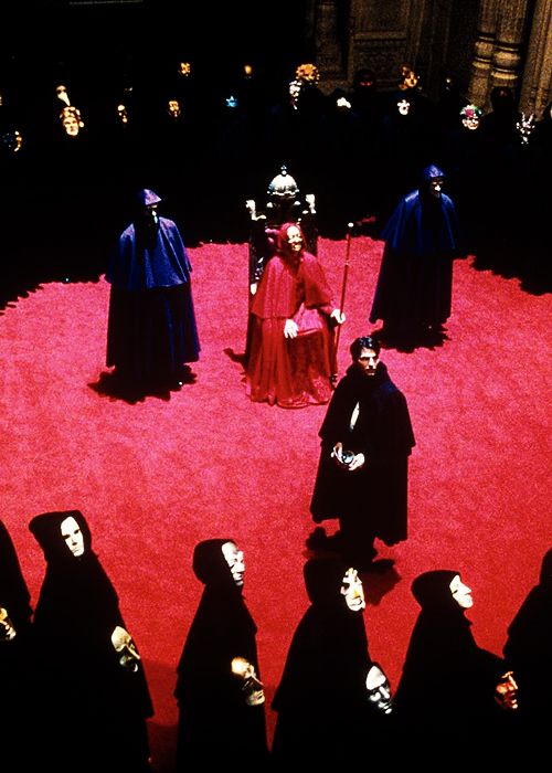 a group of people standing on top of a red carpet in front of a crowd