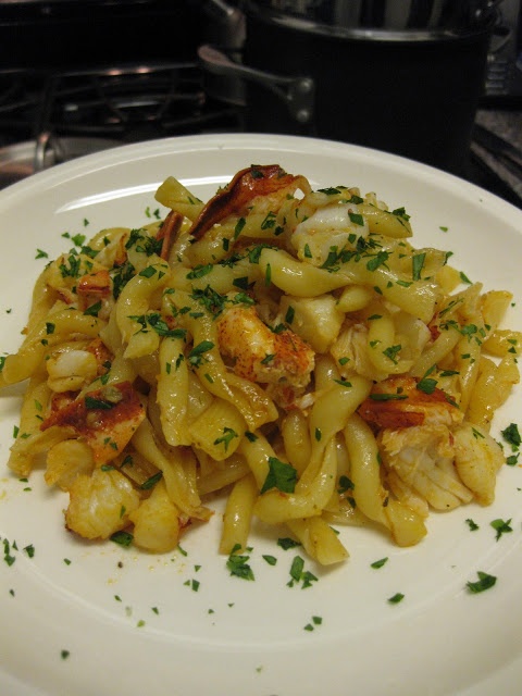 a white plate topped with pasta and shrimp