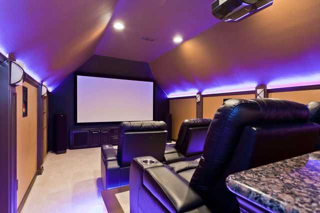 a home theater with purple lighting and leather seats