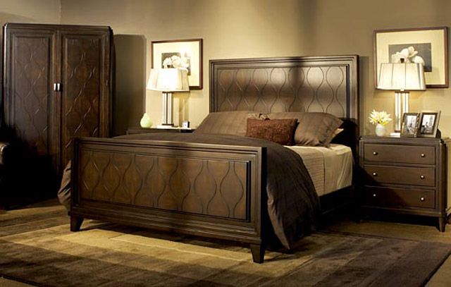 a bed room with a neatly made bed and dressers