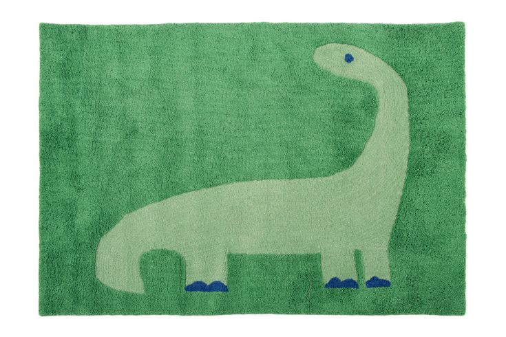 a green rug with a white dinosaur on it