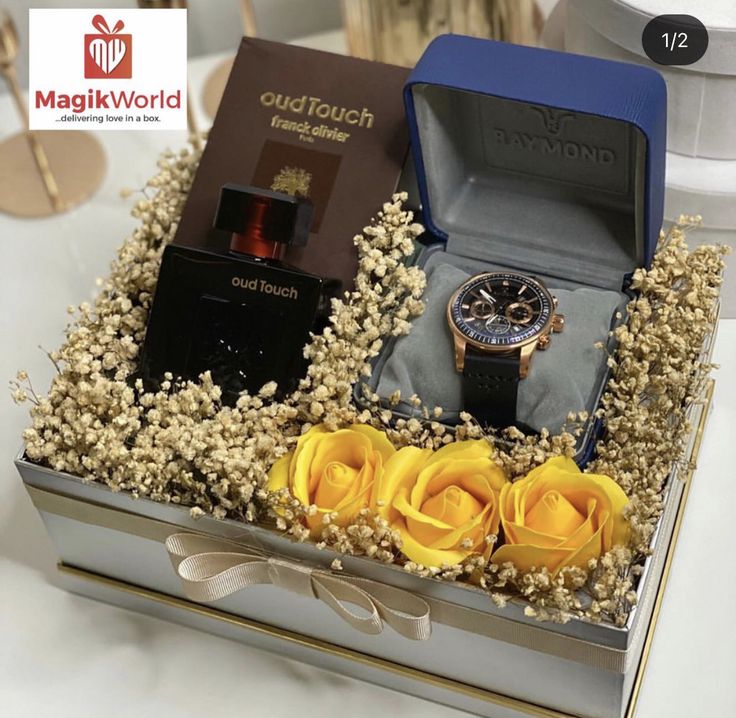 a watch and some yellow roses in a box on a table with other items for sale