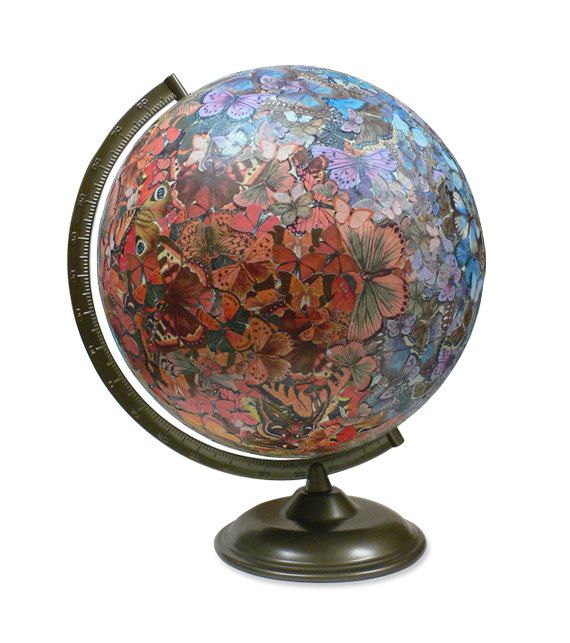 a colorful glass globe with butterflies on it's sides and a metal stand for the base