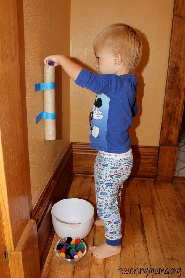 a toddler is playing with his toys in the bathroom and it looks like he's trying to do something