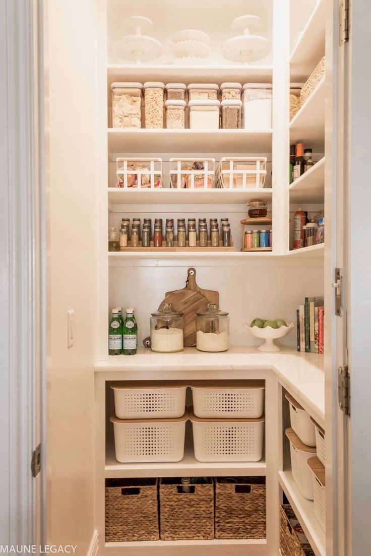 an organized pantry with baskets and food items in the bottom shelf, along with other containers