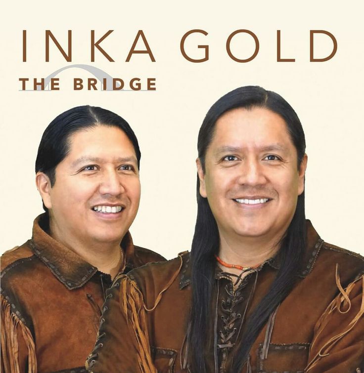 two people standing next to each other in front of a sign that says inka gold