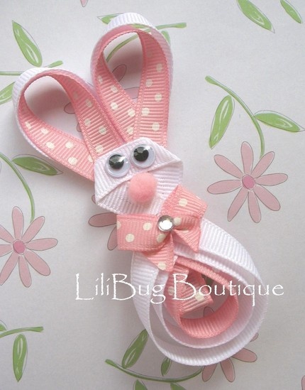 a pink and white bunny hair clip with polka dots