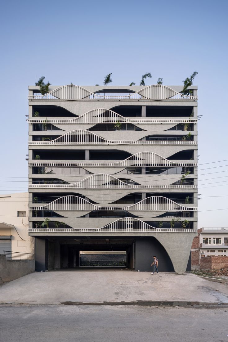 an apartment building with balconies on the roof