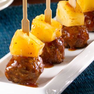 meatballs and pineapples on skewers with sauce