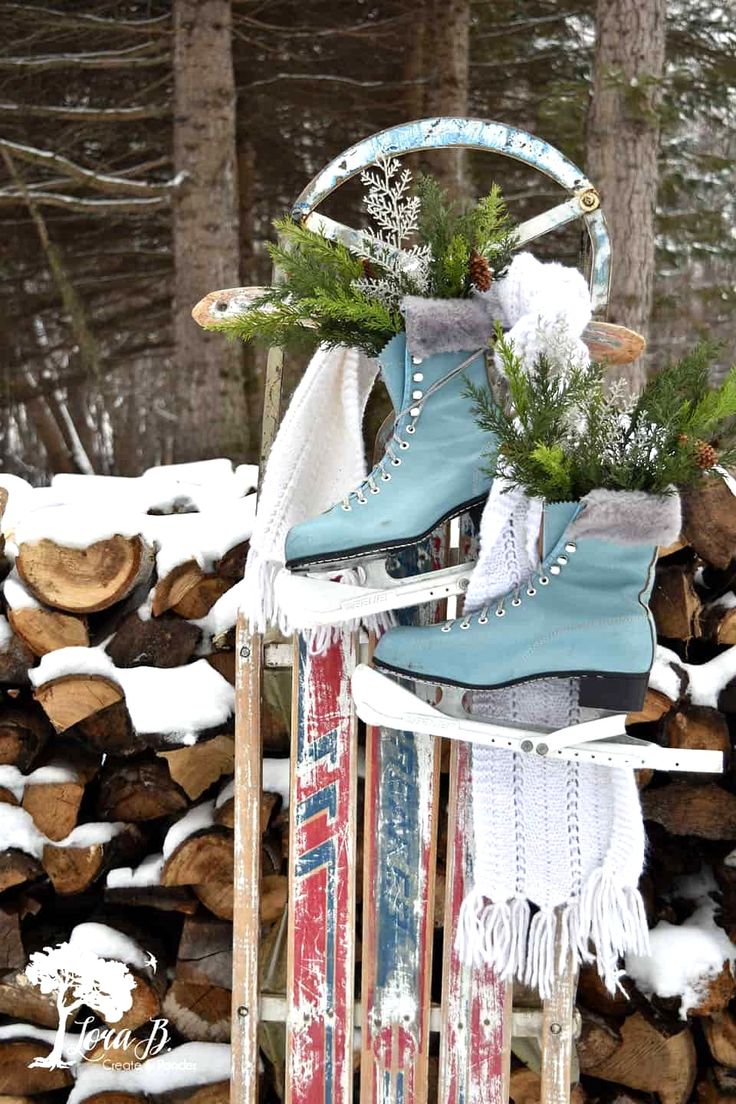 a sled with skis and snow shoes on it in the snow next to logs