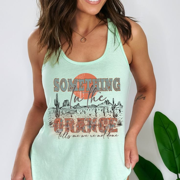 Something in the Orange tank top, American Heartbreak tour, country music shirt, festival shirt Made on super soft Next Level Tank! High quality and preshrunk tees. See size chart for details, size up for relaxed fit. **Next Level Racerback Tank Top | Runs small, size up if needed** Thank you for shopping my small business. Please message me if you have questions. This is a physical shirt that is made when you order it and shipped out to you. If you love the design and would like it on a differe Festival Cotton Top With Soft-washed Detail, Casual Soft-washed Tops For Festival, Festival Cotton Tops Soft-washed, Soft-washed Cotton Top For Festival, Spring Graphic Tee Tank Top With Letter Print, Spring Festival Tank Top With Graphic Print, Soft-washed Cotton Tops For Music Festival, Casual Fitted Tank Top With Screen Print, Fitted Casual Tank Top With Screen Print