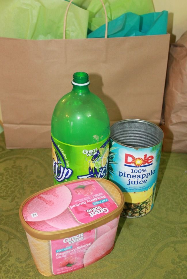 some food is sitting on a table next to a brown paper bag and plastic container