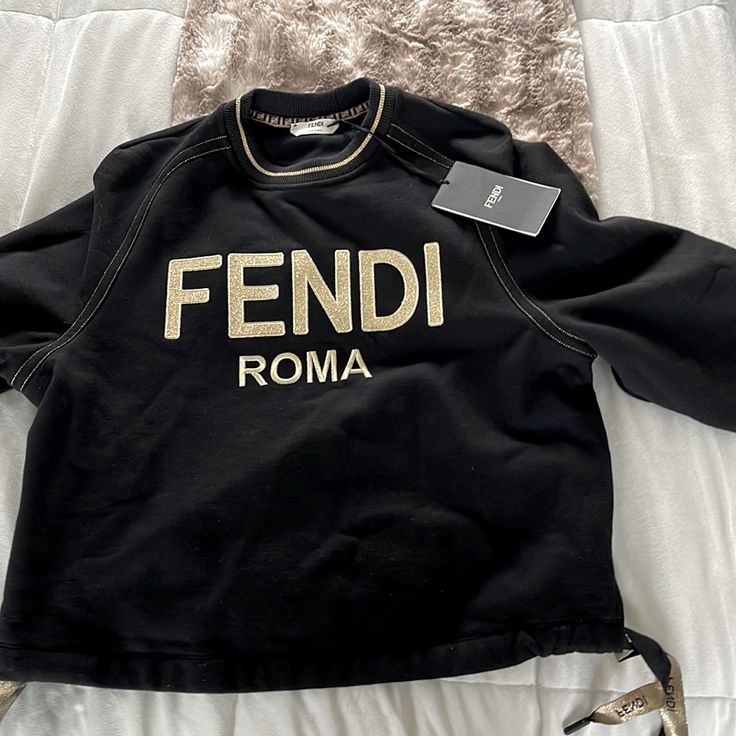 Black Fendi Sweatshirt With Ties On The Side. It’s Sort Of An Oversized Fit Fendi Sweatshirt Women, Luxury Tops With Logo Detail For Fall, Luxury Logo Tops For Fall, Luxury Logo Detail Tops For Fall, Designer Embroidered Logo Tops For Fall, Luxury Long Sleeve Tops With Logo Detail, Luxury Black Sweatshirt With Embroidered Logo, Luxury Long Sleeve Tops With Embroidered Logo, Luxury Long Sleeve Top With Embroidered Logo