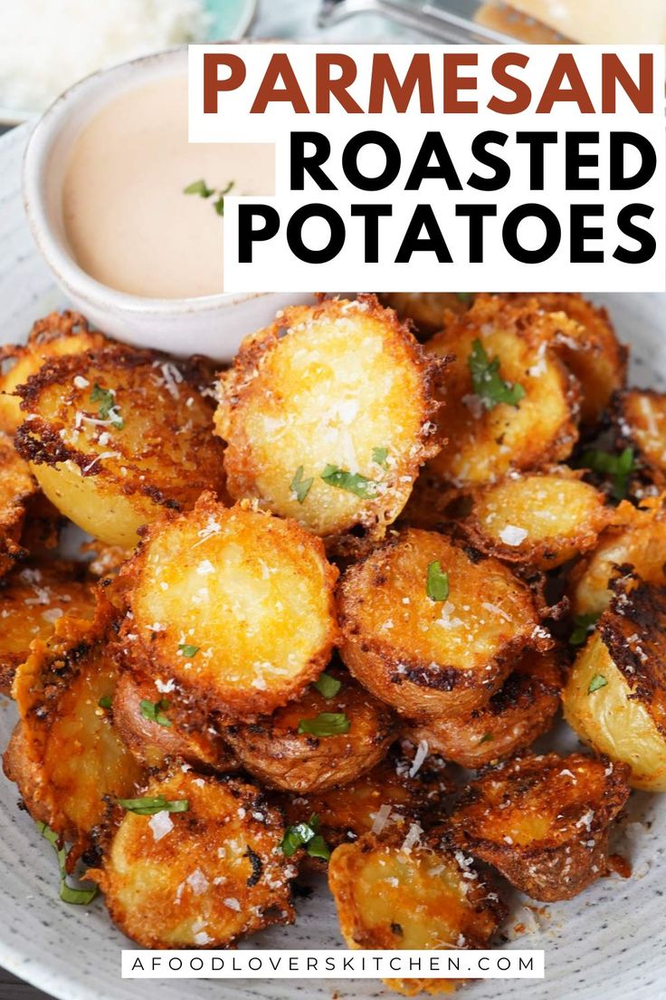 parmesan roasted potatoes on a plate with ranch dressing in the background and text overlay