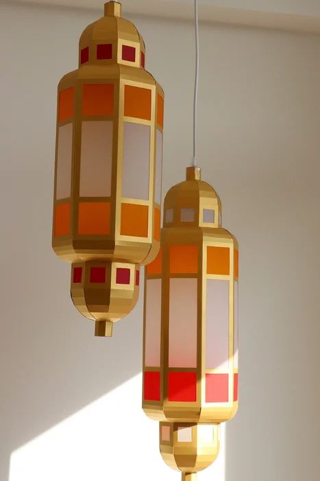 two lamps hanging from a ceiling in a room