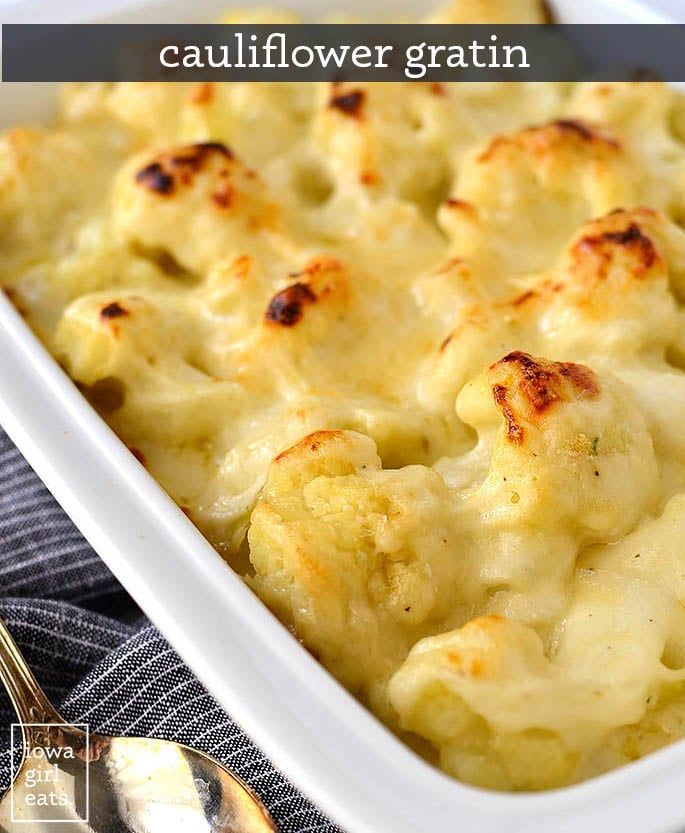 a white casserole dish with cauliflower gratin in it on a table