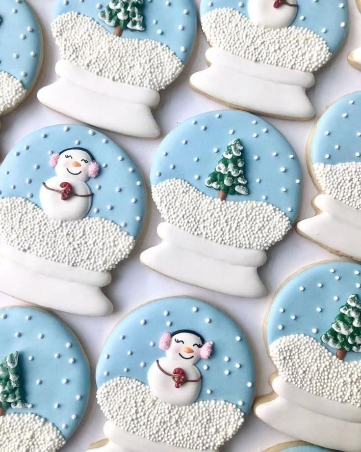 decorated cookies with snowmen and trees on them