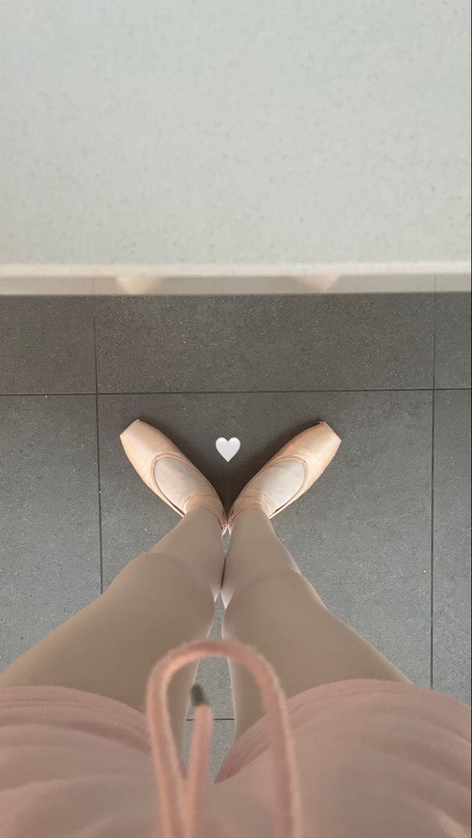 a woman's legs in high heels with a white heart on the top and bottom