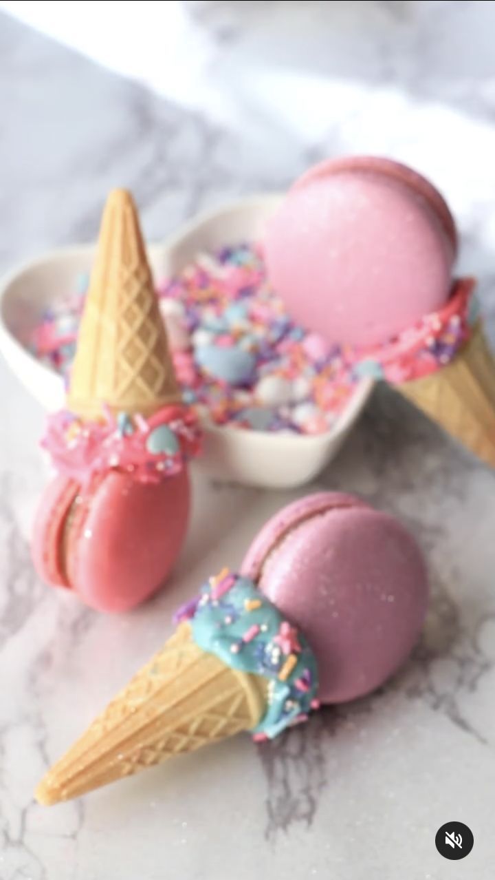 three ice cream cones with sprinkles in bowls on a marble countertop