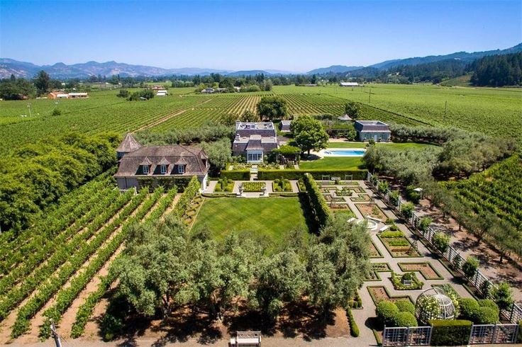 an aerial view of a large estate in the middle of a field with lots of trees