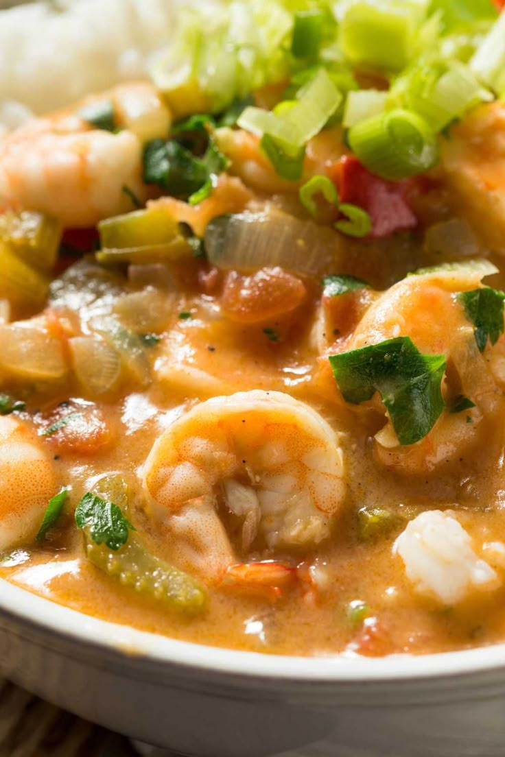 a white bowl filled with shrimp and vegetable soup