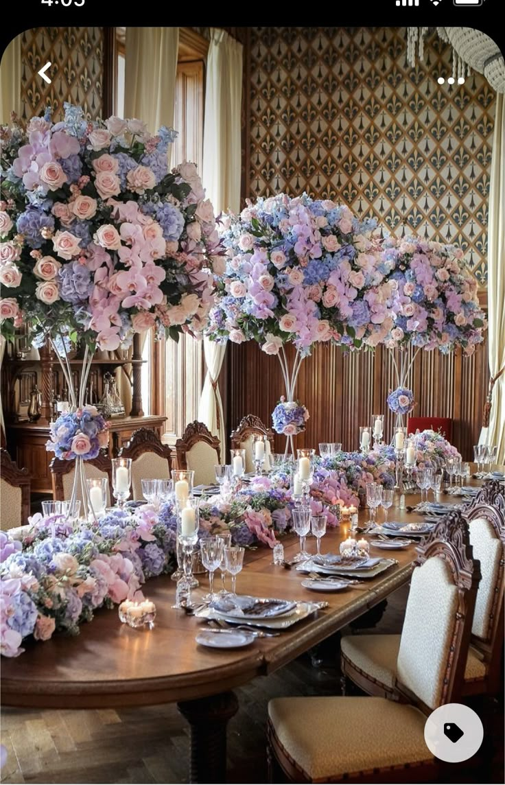 a dining room table is set with flowers and candles for an elegant dinnereon party