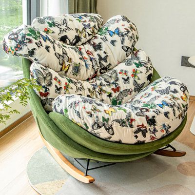 a green chair sitting in front of a window