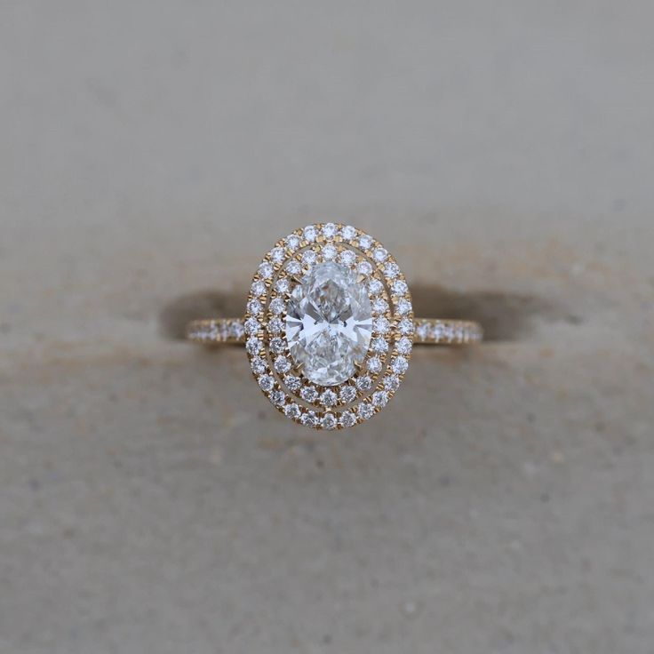 an oval shaped diamond engagement ring with double halos