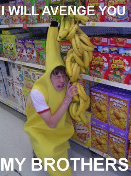 a person in a banana costume is holding bananas up to their head while standing next to a store shelf