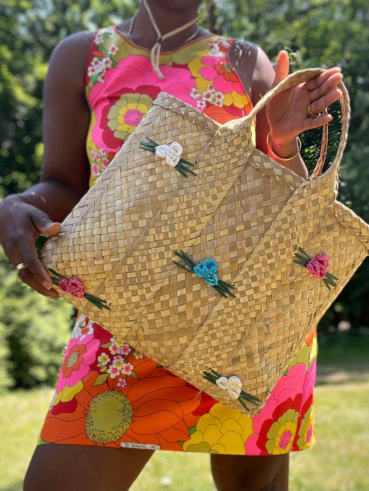 The perfect accessory for warm weather days, this Straw Floret Tote is the essential summer accessory. Crafted with natural straw, this tote bag is adorned with bright and colorful summer flowers for a vibrant addition to your wardrobe. 100% straw grass Handmade  18"W x 14"H x 4"D Weather Day, Summer Accessories, Summer Flowers, Warm Weather, Straw, Tote Bag, Etsy Uk, Flowers, Color