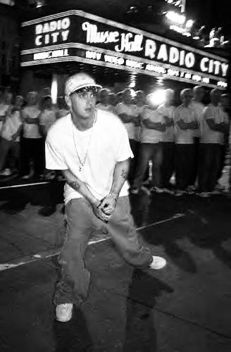 a man standing on top of a street next to a crowd