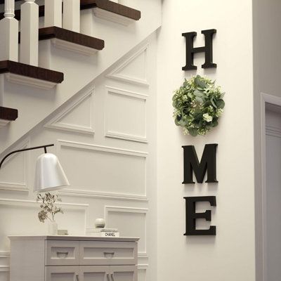 a living room with white walls and stairs