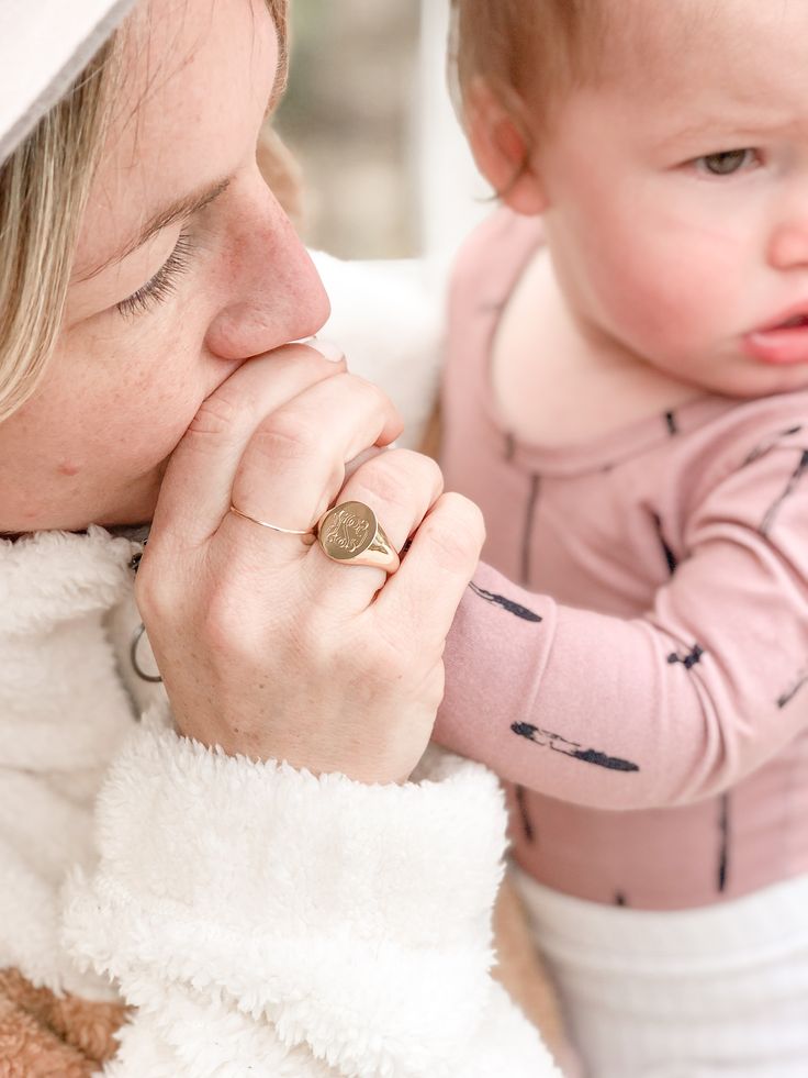 a woman holding a baby in her arms