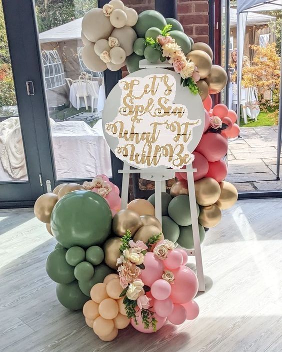 a birthday cake made out of balloons and flowers with a sign that says happy 20th birthday mum