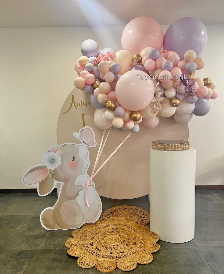 a balloon bouquet with an elephant and bunny on it