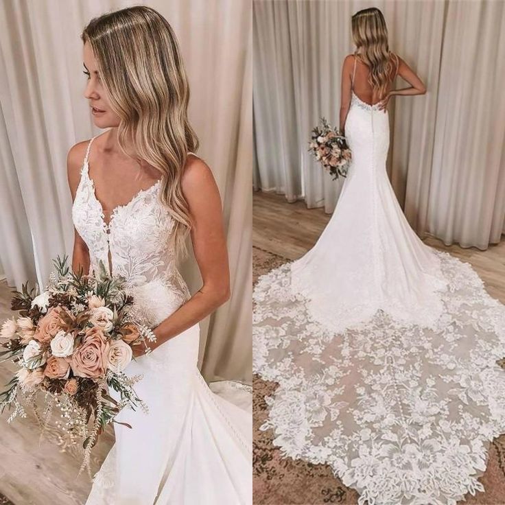 a woman in a wedding dress holding a bouquet and looking at her reflection in the mirror