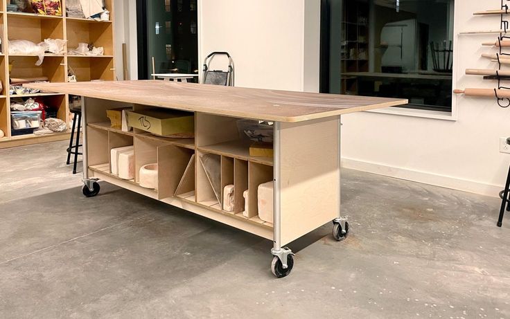 a kitchen island made out of plywood with shelves on each side and storage bins at the top