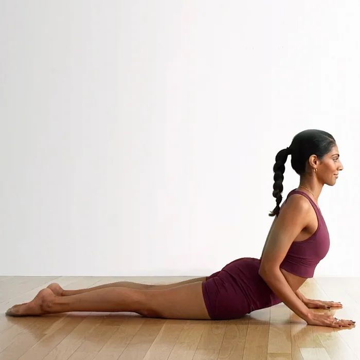 a woman is doing yoga on the floor